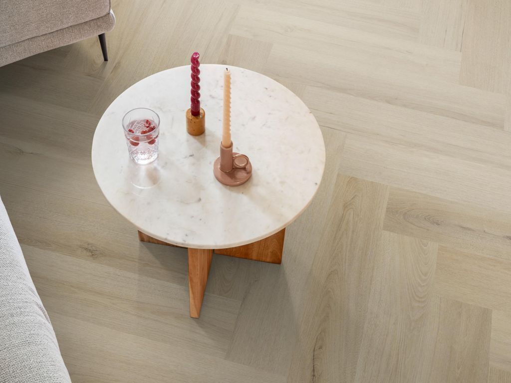 Ambiant Spigato XL Valento Visgraat Click 6081.2014.19 Smoky visgraat click pvc onder ronde marmeren salontafel met gekleurde kaarsen